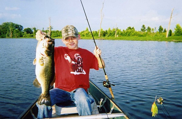 Hudson Wilson (Manager Wilson's grandson) with a 9 lb bass from a Donavan lake,  July of 07.
